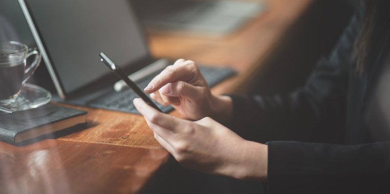 surfing internet on tablet near open laptop.jpg